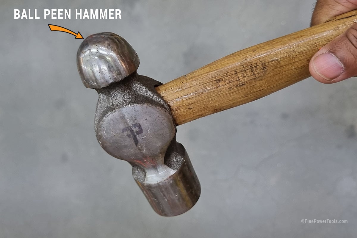 Man holding a ball peen hammer